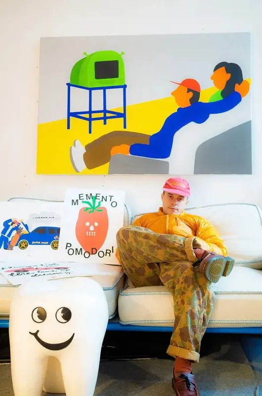 a designer in the studio, prints on the wall